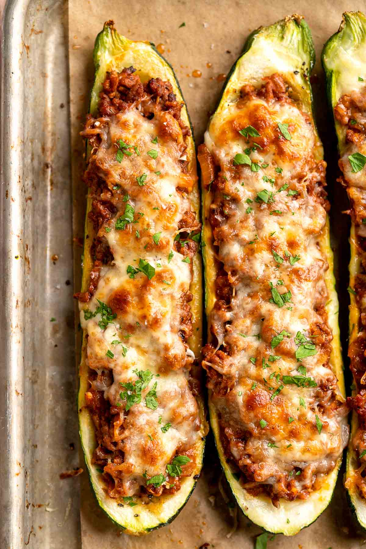 Stuffed Zucchini Boats are a fun, low carb dinner filled with a hearty meat sauce, topped with cheese, and baked until melty and bubbly. | aheadofthyme.com