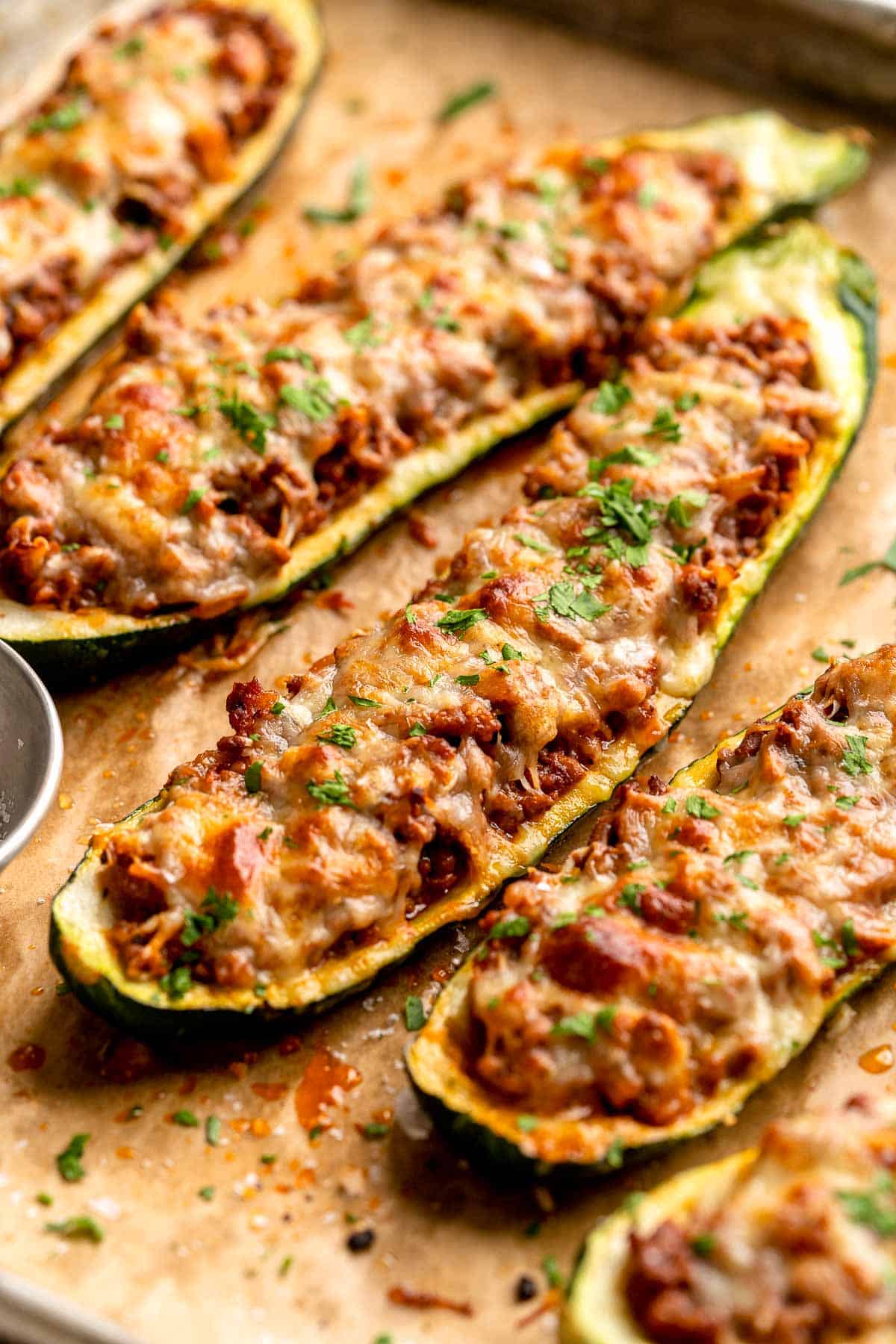 Stuffed Zucchini Boats are a fun, low carb dinner filled with a hearty meat sauce, topped with cheese, and baked until melty and bubbly. | aheadofthyme.com