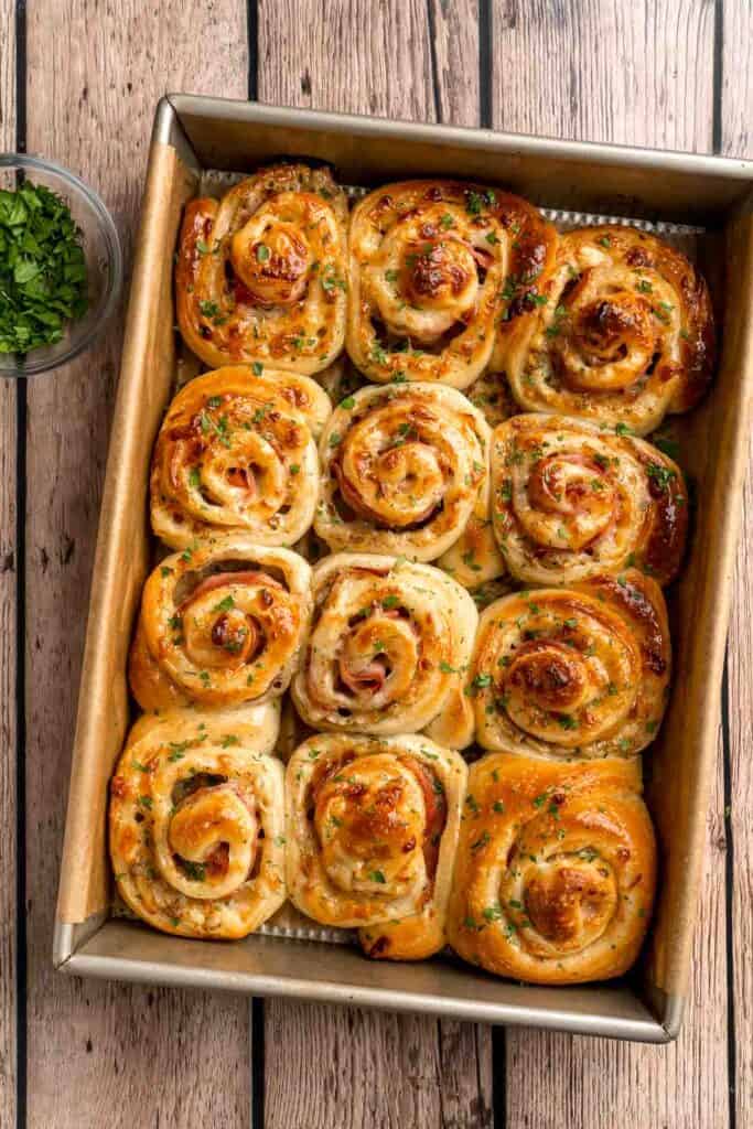 Freshly baked from the oven, these Ham and Cheese Pinwheels are warm and tender with gooey melty cheese and sweet ham. Perfect for lunch or dinner! | aheadofthyme.com