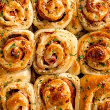 Freshly baked from the oven, these Ham and Cheese Pinwheels are warm and tender with gooey melty cheese and sweet ham. Perfect for lunch or dinner! | aheadofthyme.com