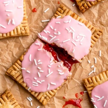 These Homemade Pop Tarts buttery, flaky, and filled with sweet strawberry jam with a pink vanilla glaze on top — a major upgrade on the store-bought kind! | aheadofthyme.com