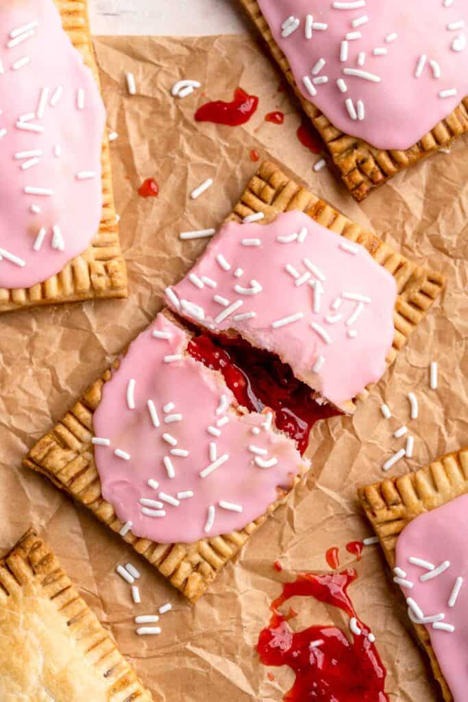 These Homemade Pop Tarts buttery, flaky, and filled with sweet strawberry jam with a pink vanilla glaze on top - a major upgrade on the store-bought kind! | aheadofthyme.com