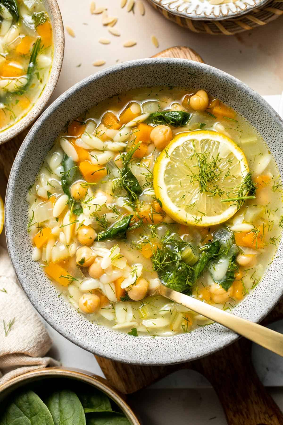 Lemon Chickpea Orzo Soup is a hearty vegan soup loaded with simple ingredients including veggies, chickpeas, and orzo pasta — ready in under 30 minutes. | aheadofthyme.com