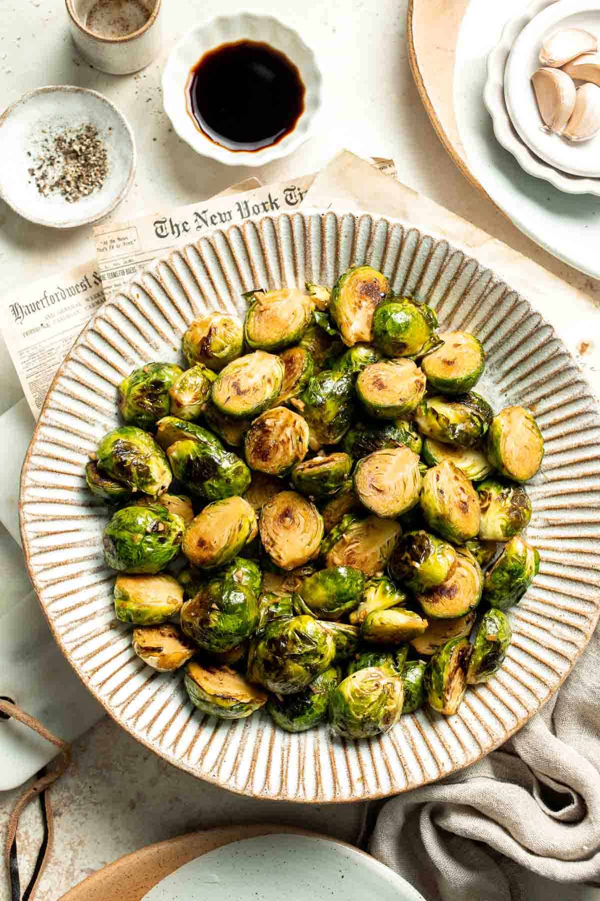Balsamic Brussels Sprouts are garlicky, salty, and sweet. They are sautéed and coated with a glossy, tangy balsamic glaze and ready in just 15 minutes! | aheadofthyme.com