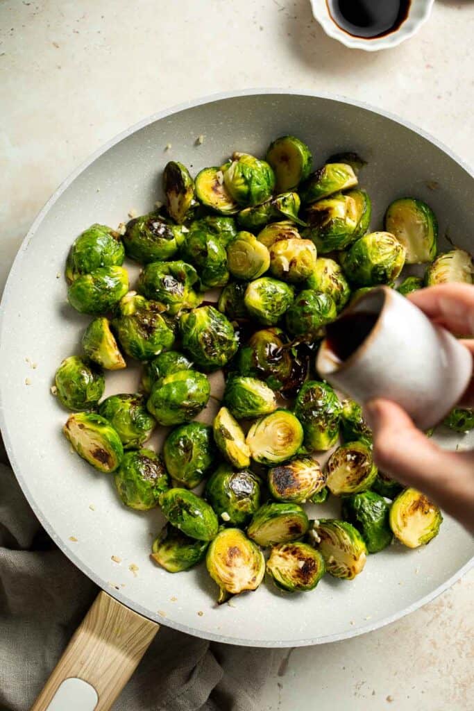 Balsamic Brussels Sprouts are garlicky, salty, and sweet. They are sautéed and coated with a glossy, tangy balsamic glaze and ready in just 15 minutes! | aheadofthyme.com