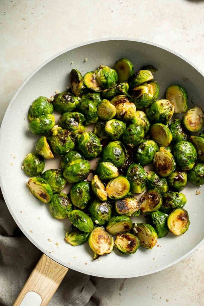Balsamic Brussels Sprouts are garlicky, salty, and sweet. They are sautéed and coated with a glossy, tangy balsamic glaze and ready in just 15 minutes! | aheadofthyme.com