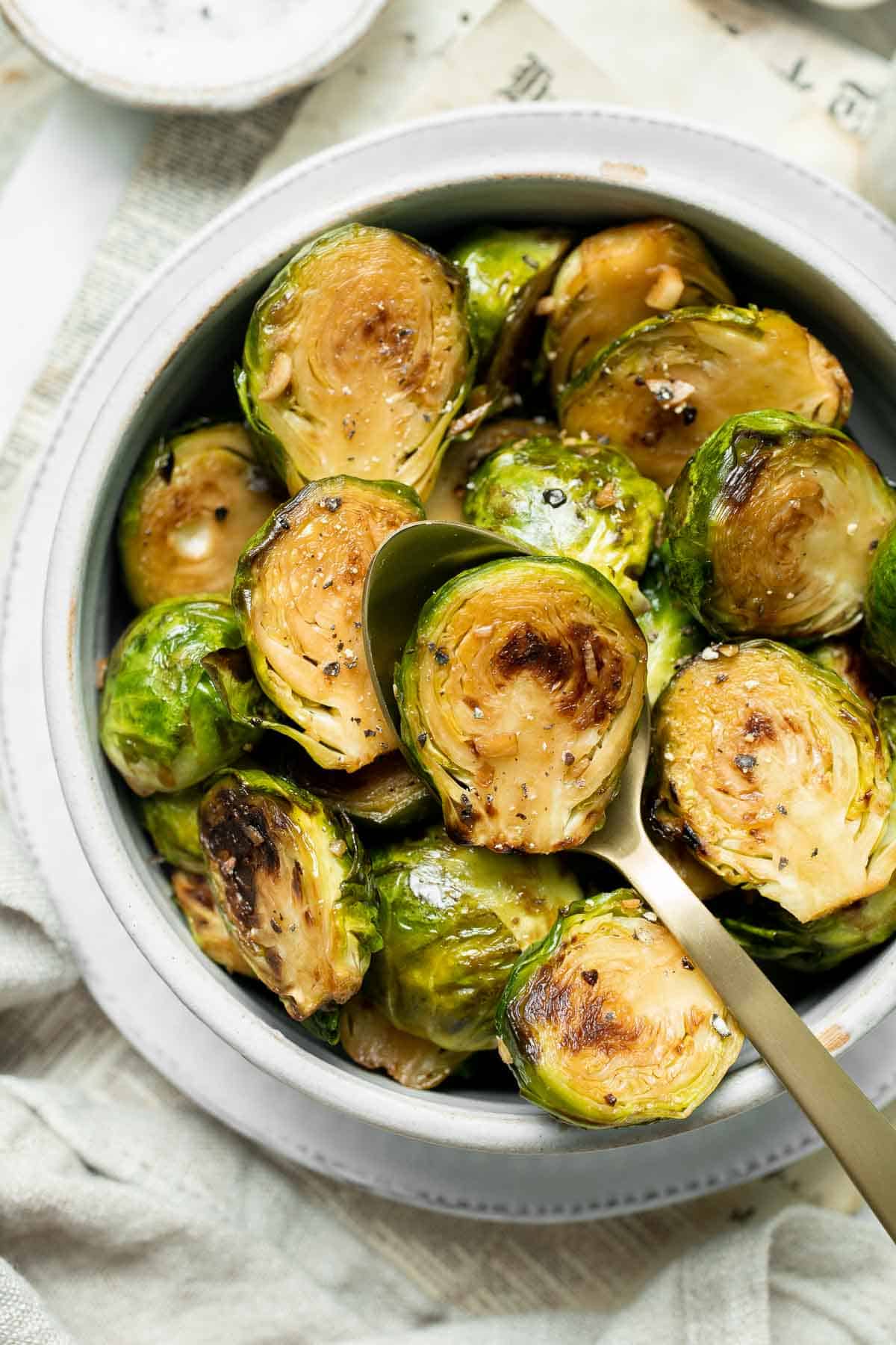 Balsamic Brussels Sprouts are garlicky, salty, and sweet. They are sautéed and coated with a glossy, tangy balsamic glaze and ready in just 15 minutes! | aheadofthyme.com