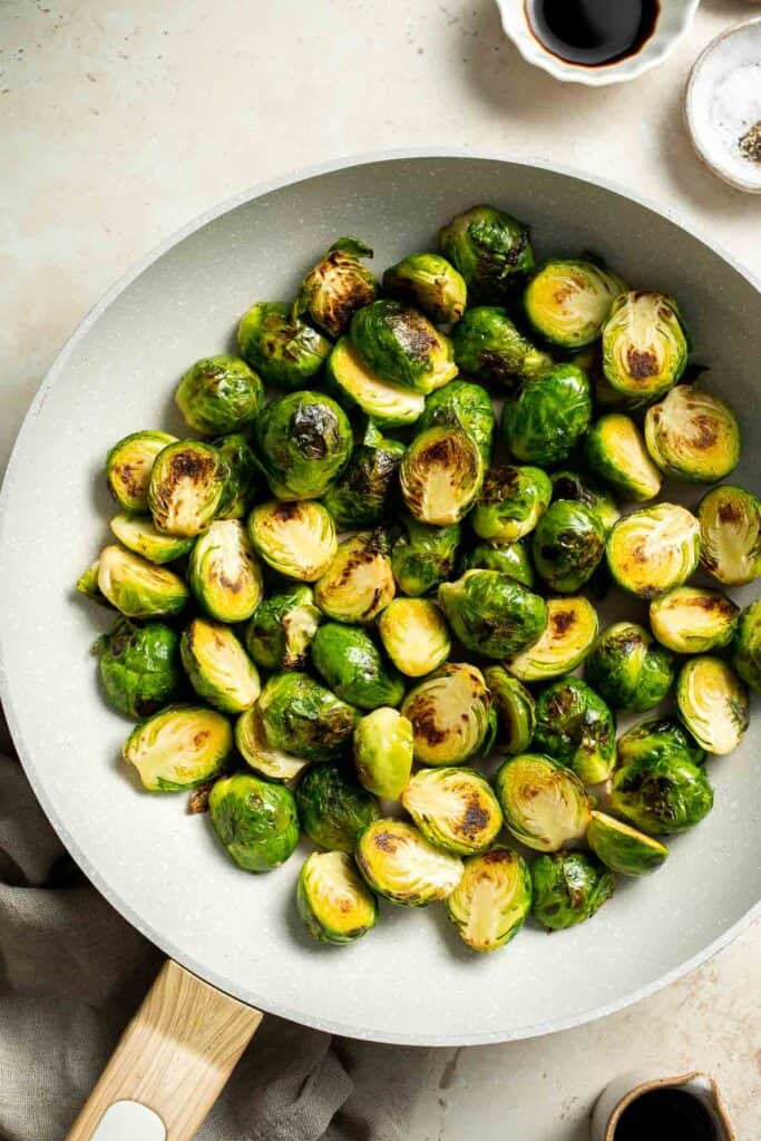 Balsamic Brussels Sprouts are garlicky, salty, and sweet. They are sautéed and coated with a glossy, tangy balsamic glaze and ready in just 15 minutes! | aheadofthyme.com