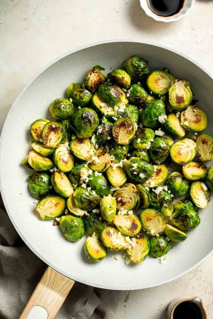 Balsamic Brussels Sprouts are garlicky, salty, and sweet. They are sautéed and coated with a glossy, tangy balsamic glaze and ready in just 15 minutes! | aheadofthyme.com