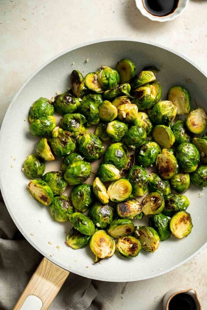 Balsamic Brussels Sprouts are garlicky, salty, and sweet. They are sautéed and coated with a glossy, tangy balsamic glaze and ready in just 15 minutes! | aheadofthyme.com