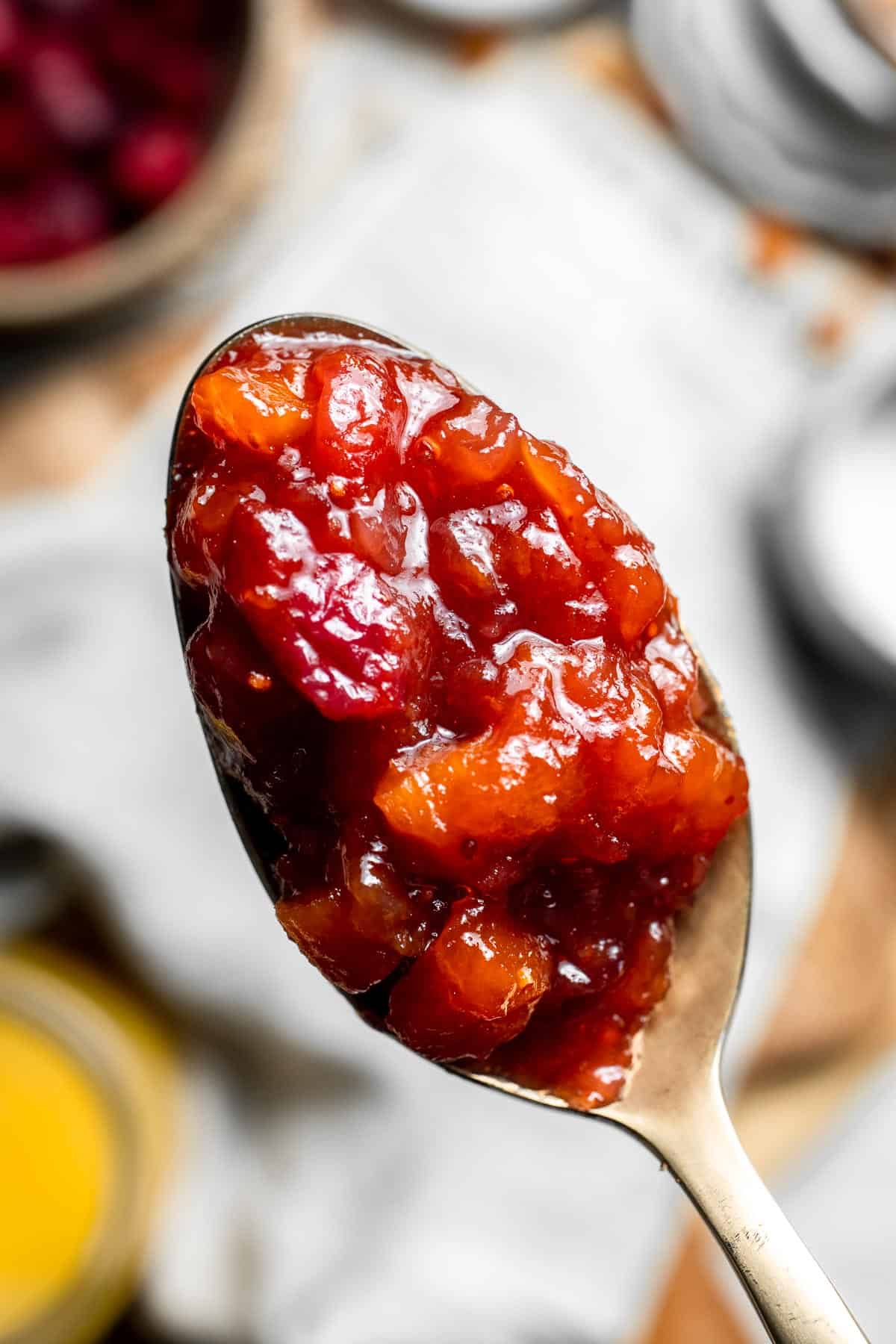 Sweet and savory Cranberry Chutney is a tangy condiment made from tart cranberries, sweet dried apricots, and savory aromatics. Ready in 30 minutes! | aheadofthyme.com