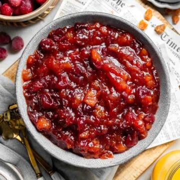 Sweet and savory Cranberry Chutney is a tangy condiment made from tart cranberries, sweet dried apricots, and savory aromatics. Ready in 30 minutes! | aheadofthyme.com