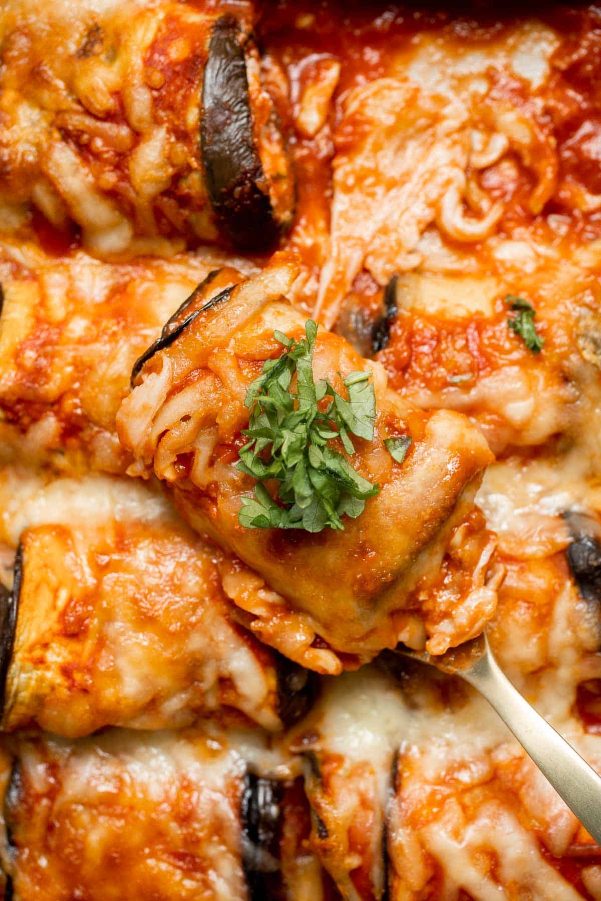 Eggplant Rollatini features roasted eggplant stuffed with creamy ricotta, baked in marinara, and topped with cheese — the best vegetarian comfort food! | aheadofthyme.com