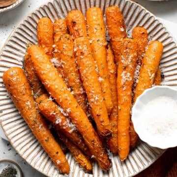 These Garlic Parmesan Roasted Carrots add a savory, cheesy flavor to any meal and are ready in just over 30 minutes! A quick and delicious side dish. | aheadofthyme.com