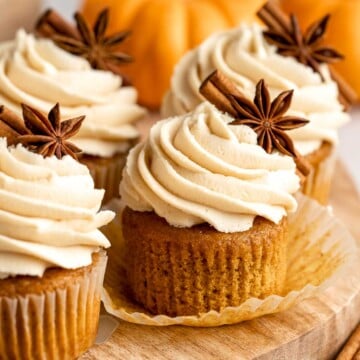 These Pumpkin Cupcakes are topped with brown butter maple buttercream and made with real pumpkin for an ultra-moist, melt-in-your-mouth texture. | aheadofthyme.com
