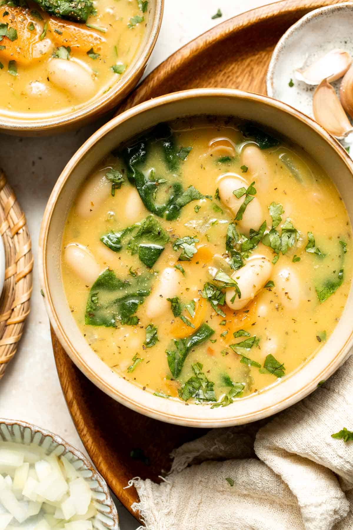 This Tuscan White Bean Soup is comforting, nourishing, and delicious, packed with creamy cannellini beans, fresh veggies, and herbs. Ready in 30 minutes! | aheadofthyme.com