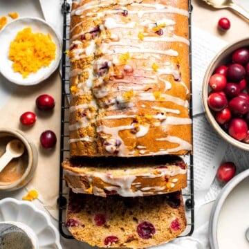 This Cranberry Orange Bread is moist and tender, loaded with fresh cranberries and zesty orange, and drizzled with homemade orange glaze on top. | aheadofthyme.com