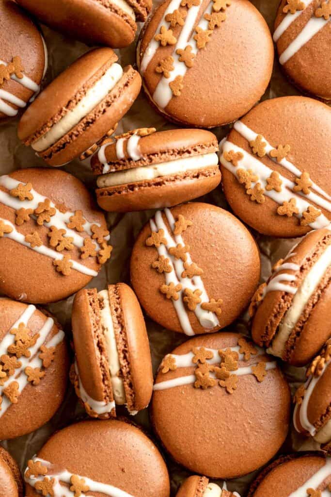 Gingerbread Macarons with spiced gingerbread shells, molasses buttercream, and white chocolate and cookie topping are a festive bite-sized treat. | aheadofthyme.com