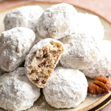 Mexican Wedding Cookies are a classic treat known for their snow-white powdered sugar coating and pecan-studded shortbread that melts in your mouth. | aheadofthyme.com