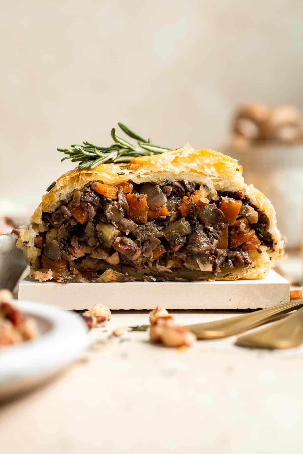 Mushroom Wellington is a vegetarian entree filled with mushrooms, vegetables, fresh herbs, and pecans, wrapped in flaky puff pastry and baked until golden. | aheadofthyme.com