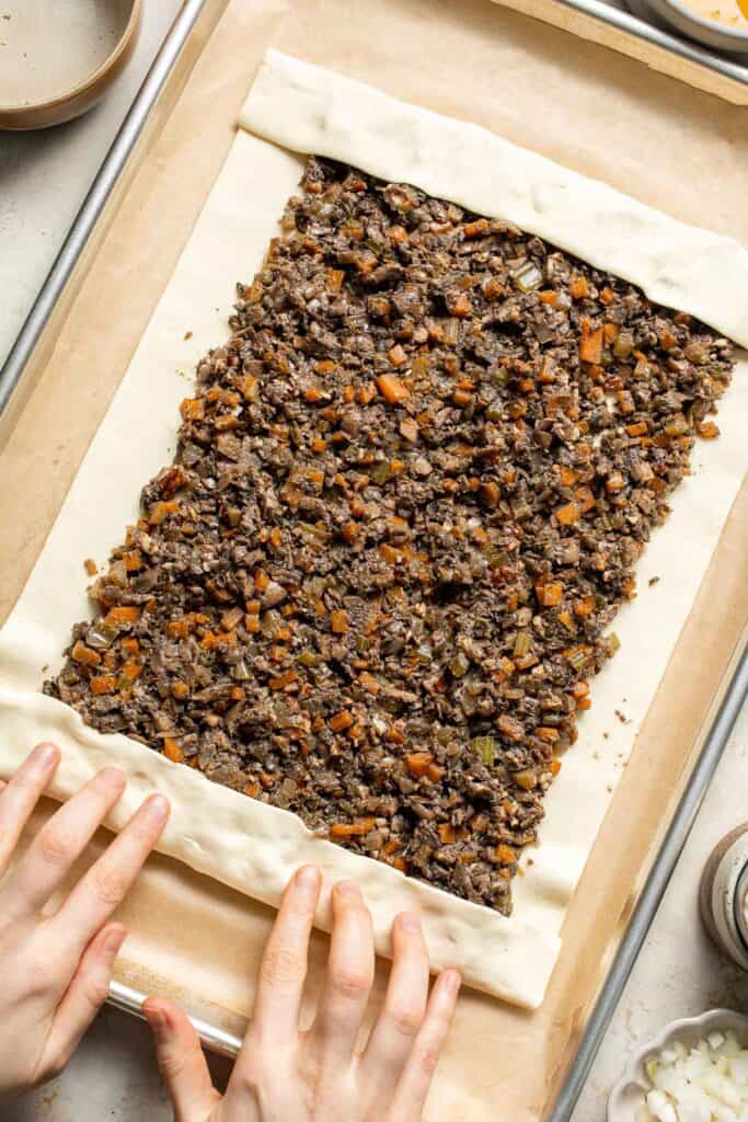 Mushroom Wellington is a vegetarian entree filled with mushrooms, vegetables, fresh herbs, and pecans, wrapped in flaky puff pastry and baked until golden. | aheadofthyme.com
