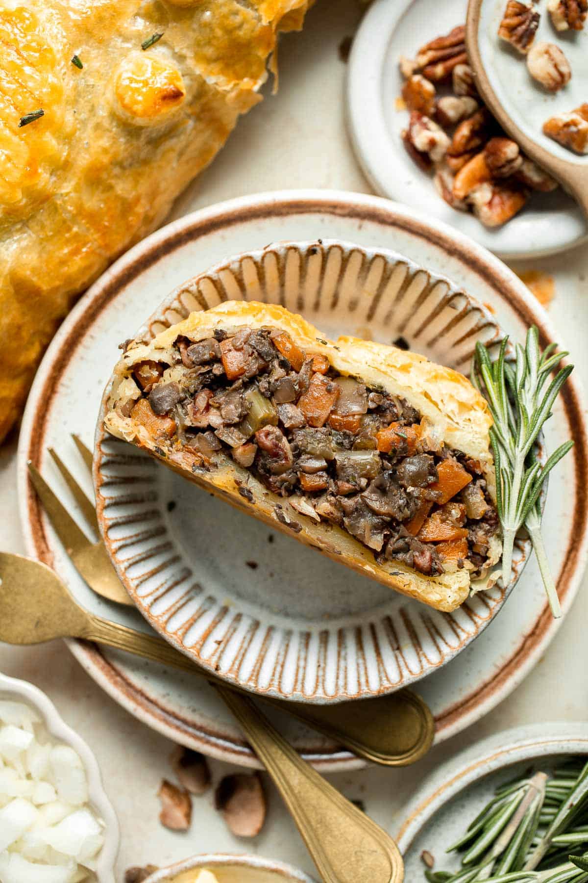 Mushroom Wellington is a vegetarian entree filled with mushrooms, vegetables, fresh herbs, and pecans, wrapped in flaky puff pastry and baked until golden. | aheadofthyme.com