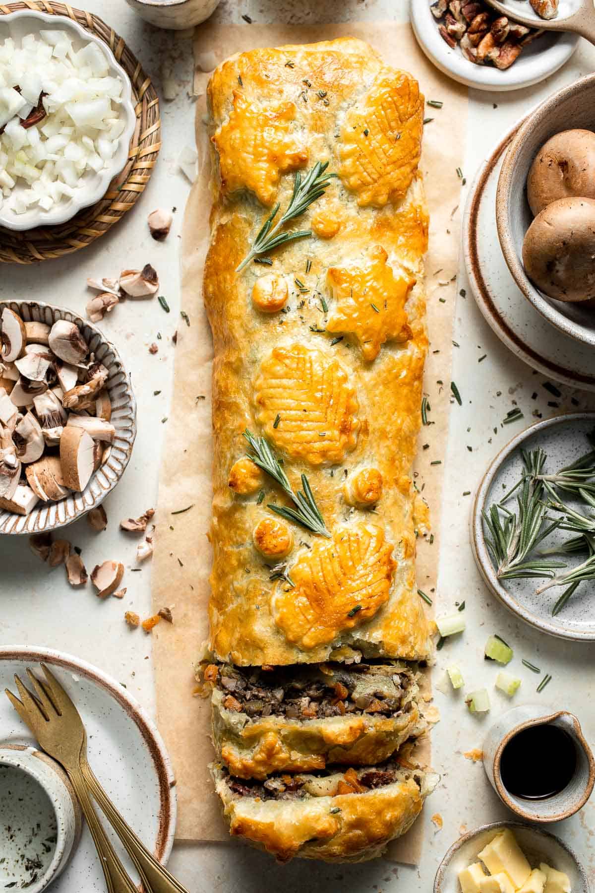 Mushroom Wellington is a vegetarian entree filled with mushrooms, vegetables, fresh herbs, and pecans, wrapped in flaky puff pastry and baked until golden. | aheadofthyme.com