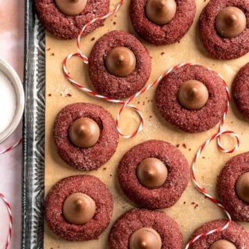 Soft and chewy Red Velvet Blossoms are a twist on the classic peanut butter blossoms with their vibrant red color, rich cocoa flavor, and chocolate kiss. | aheadofthyme.com