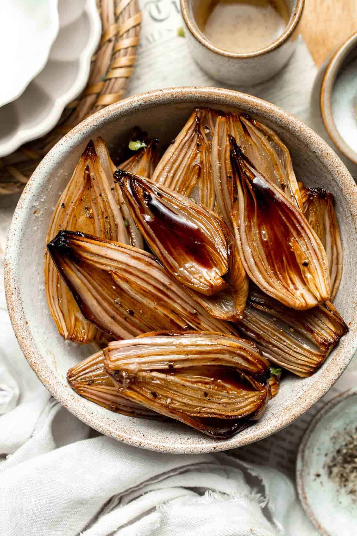 Roasted Shallots are a rich, caramelized side dish with a hint of sweetness and a kick from tangy balsamic vinegar. Ready in just 30 minutes! | aheadofthyme.com