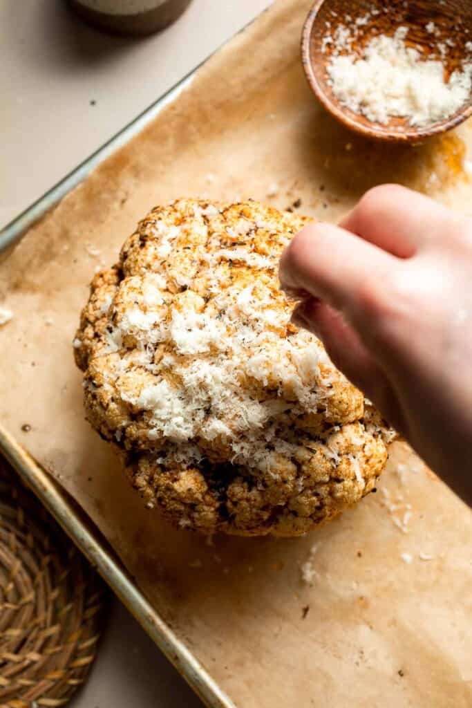 Whole Roasted Cauliflower features a flavorful crust and tender, buttery florets. It is a stunning vegetarian centerpiece that is easy to prepare. | aheadofthyme.com