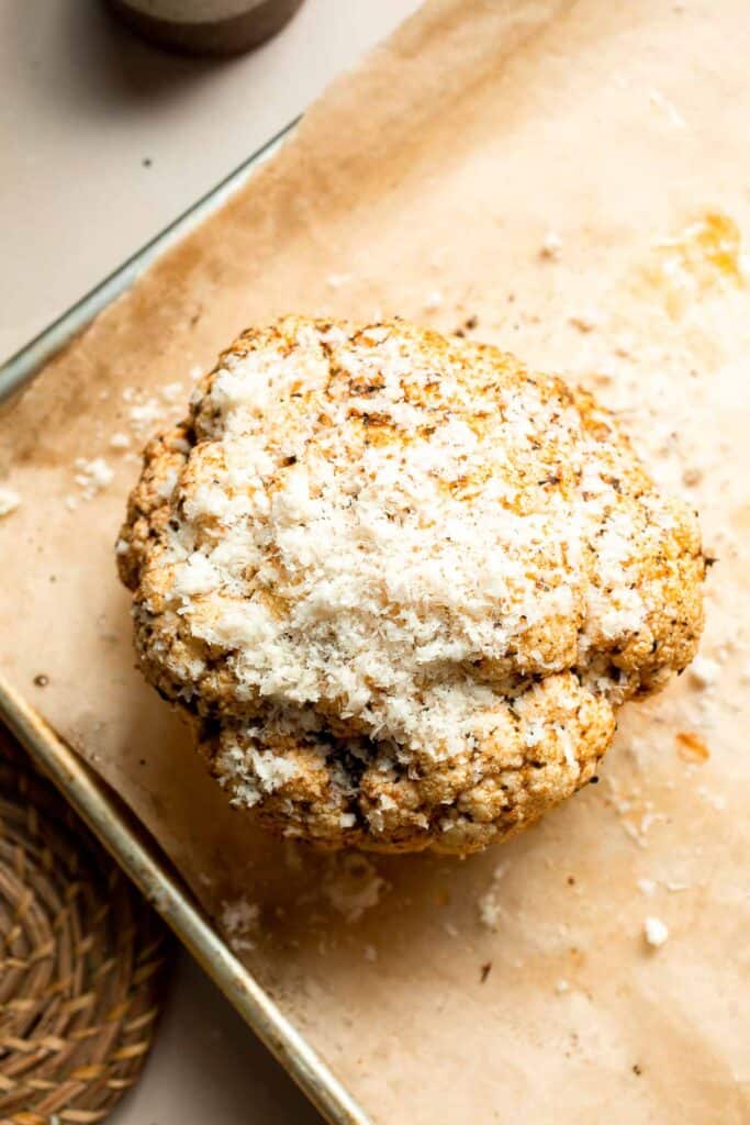 Whole Roasted Cauliflower features a flavorful crust and tender, buttery florets. It is a stunning vegetarian centerpiece that is easy to prepare. | aheadofthyme.com