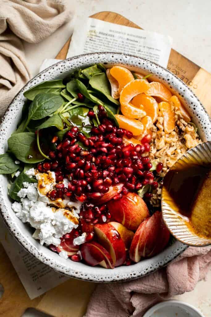 Festive Winter Pomegranate Salad is studded with sweet pomegranate seeds, apples, oranges, and feta, all tossed in a homemade balsamic vinaigrette. | aheadofthyme.com