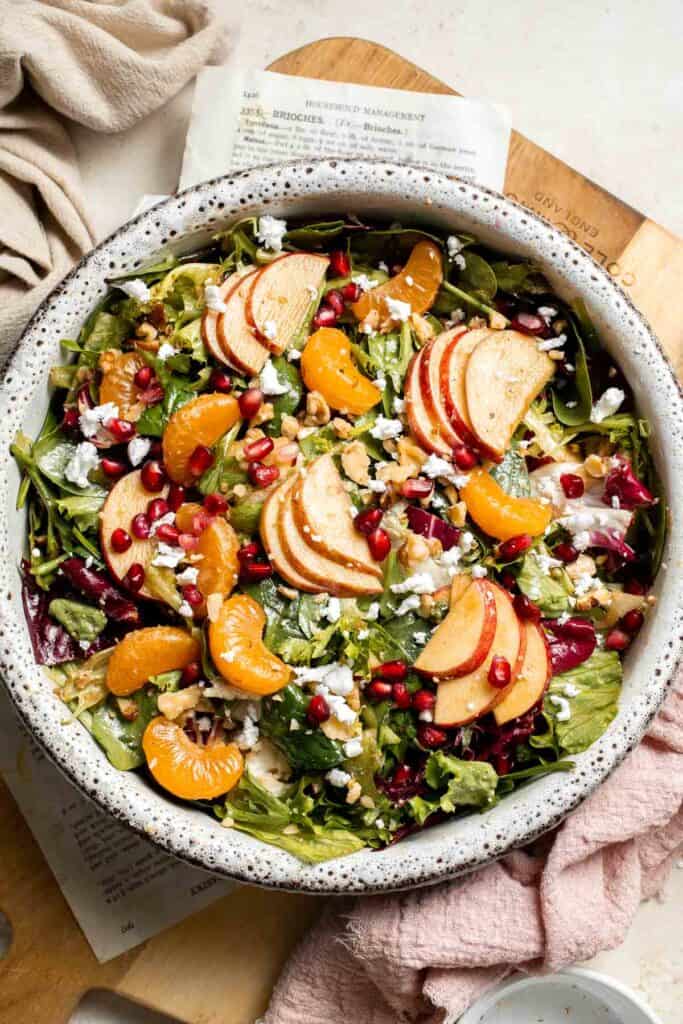 Festive Winter Pomegranate Salad is studded with sweet pomegranate seeds, apples, oranges, and feta, all tossed in a homemade balsamic vinaigrette. | aheadofthyme.com