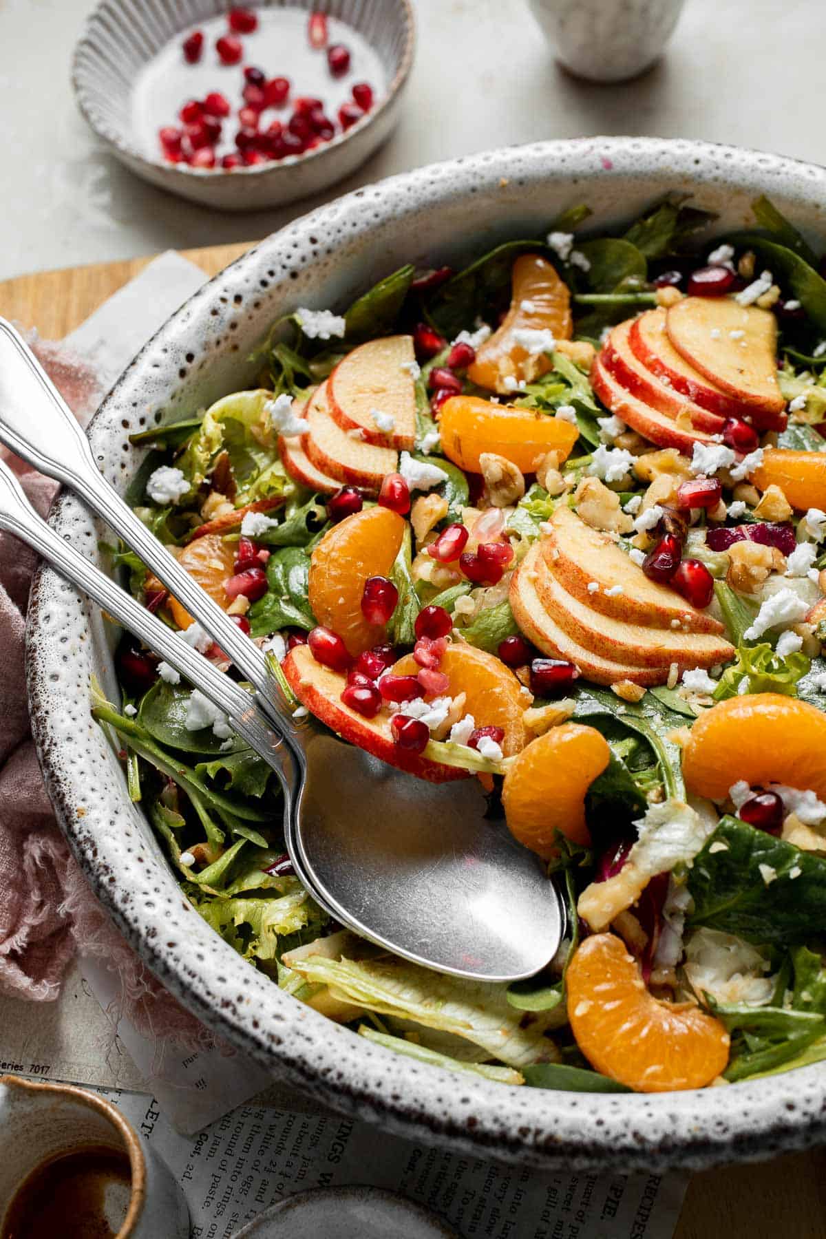 Festive Winter Pomegranate Salad is studded with sweet pomegranate seeds, apples, oranges, and feta, all tossed in a homemade balsamic vinaigrette. | aheadofthyme.com