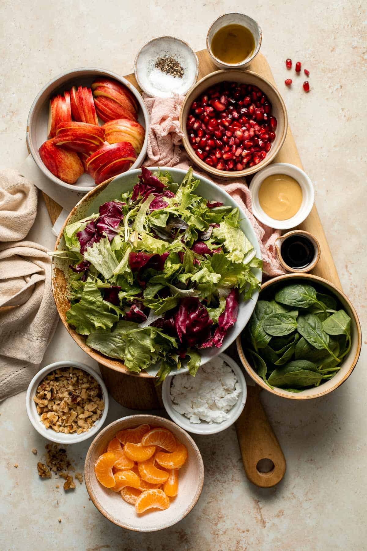 Festive Winter Pomegranate Salad is studded with sweet pomegranate seeds, apples, oranges, and feta, all tossed in a homemade balsamic vinaigrette. | aheadofthyme.com