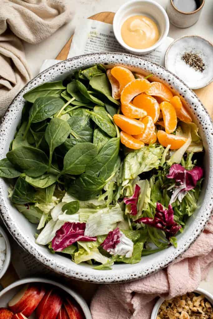 Festive Winter Pomegranate Salad is studded with sweet pomegranate seeds, apples, oranges, and feta, all tossed in a homemade balsamic vinaigrette. | aheadofthyme.com