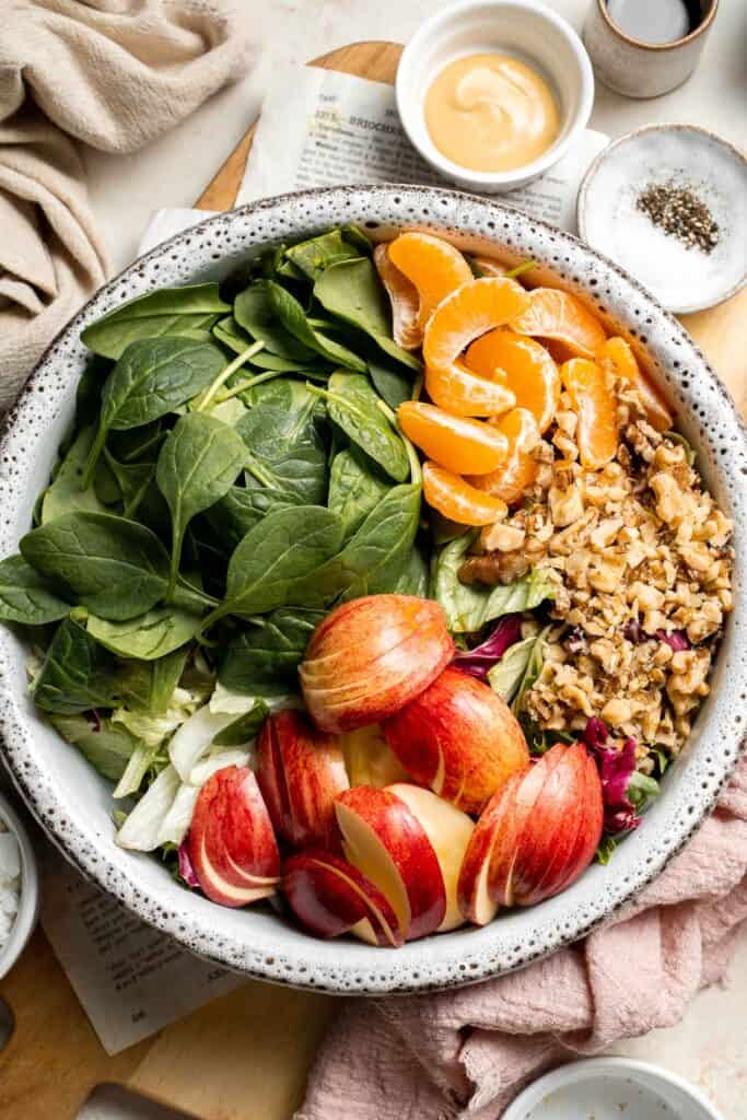 Festive Winter Pomegranate Salad is studded with sweet pomegranate seeds, apples, oranges, and feta, all tossed in a homemade balsamic vinaigrette. | aheadofthyme.com