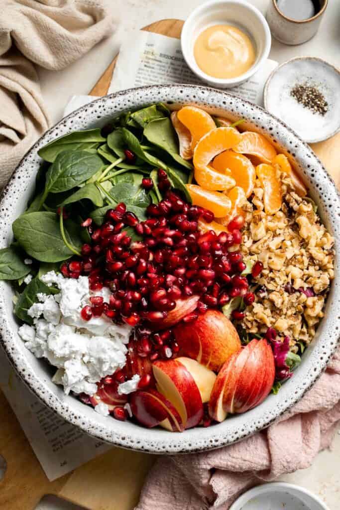 Festive Winter Pomegranate Salad is studded with sweet pomegranate seeds, apples, oranges, and feta, all tossed in a homemade balsamic vinaigrette. | aheadofthyme.com