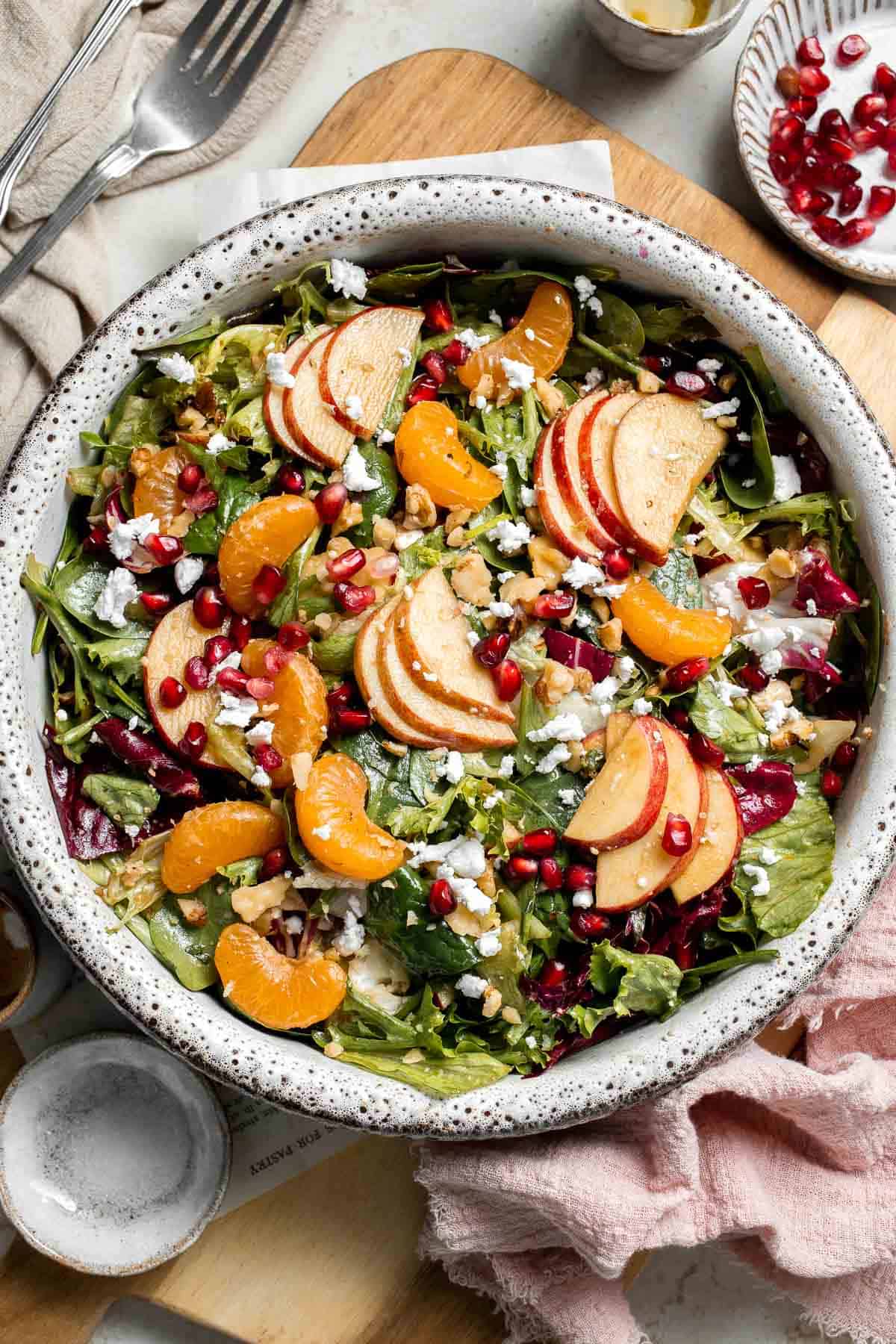 Festive Winter Pomegranate Salad is studded with sweet pomegranate seeds, apples, oranges, and feta, all tossed in a homemade balsamic vinaigrette. | aheadofthyme.com