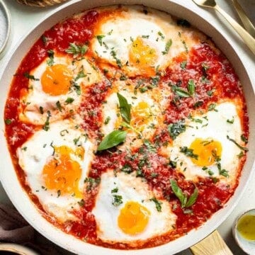 Eggs in Purgatory is made with perfectly poached eggs nestled in a rich, spicy tomato sauce, it’s a simple yet satisfying meal that’s ready in 25 minutes! | aheadofthyme.com