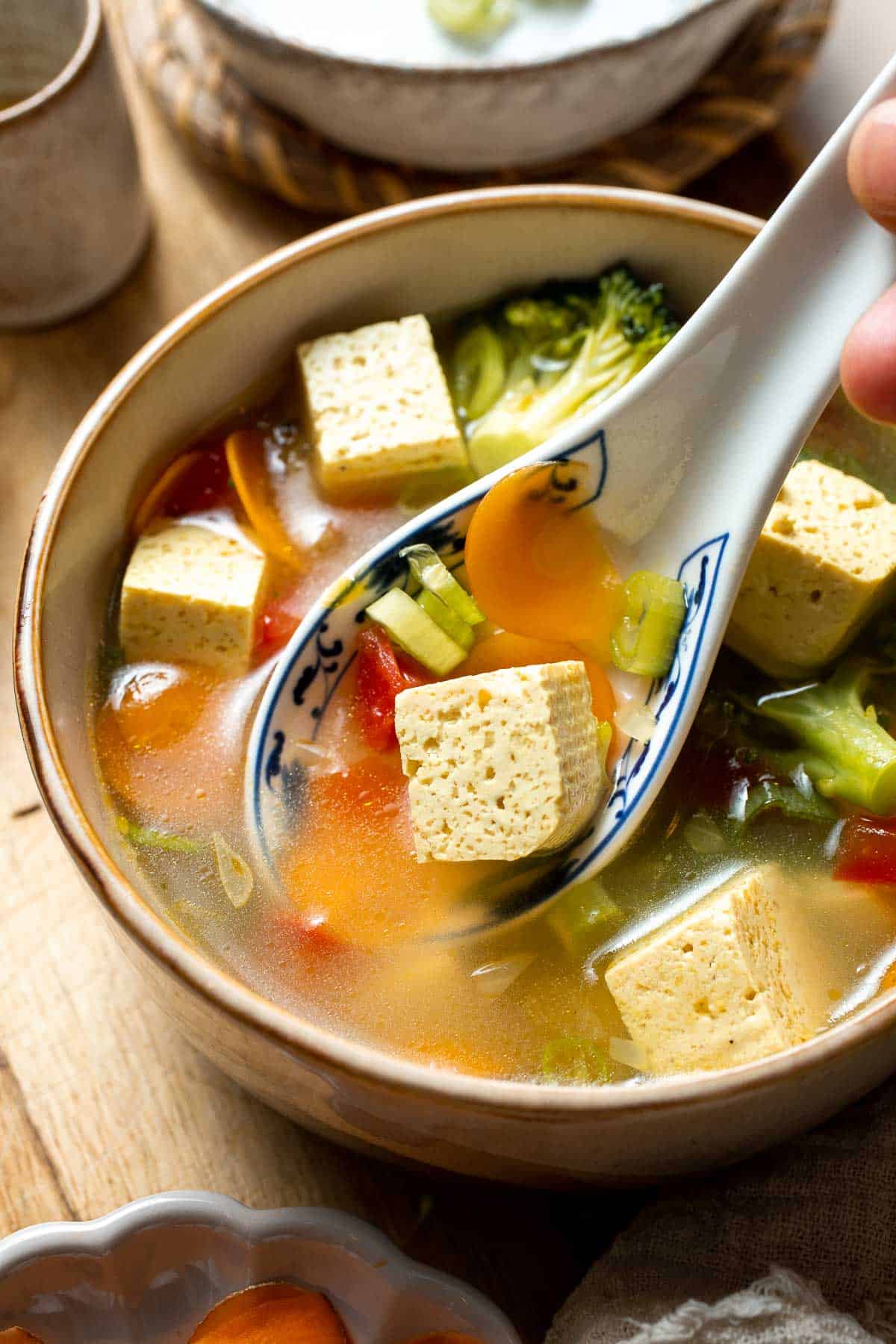 This homemade Tofu Soup is light and satisfying — with tender tofu cubes, vibrant veggies, and a savory broth for a deep, rich flavor that will warm you up. | aheadofthyme.com