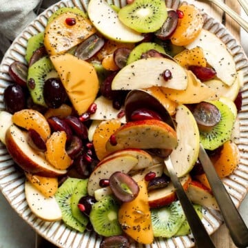 Easy Winter Fruit Salad combines juicy citrus, sweet grapes, crisp apples, permissions, and tart pomegranate, tossed together with a honey-lime dressing. | aheadofthyme.com