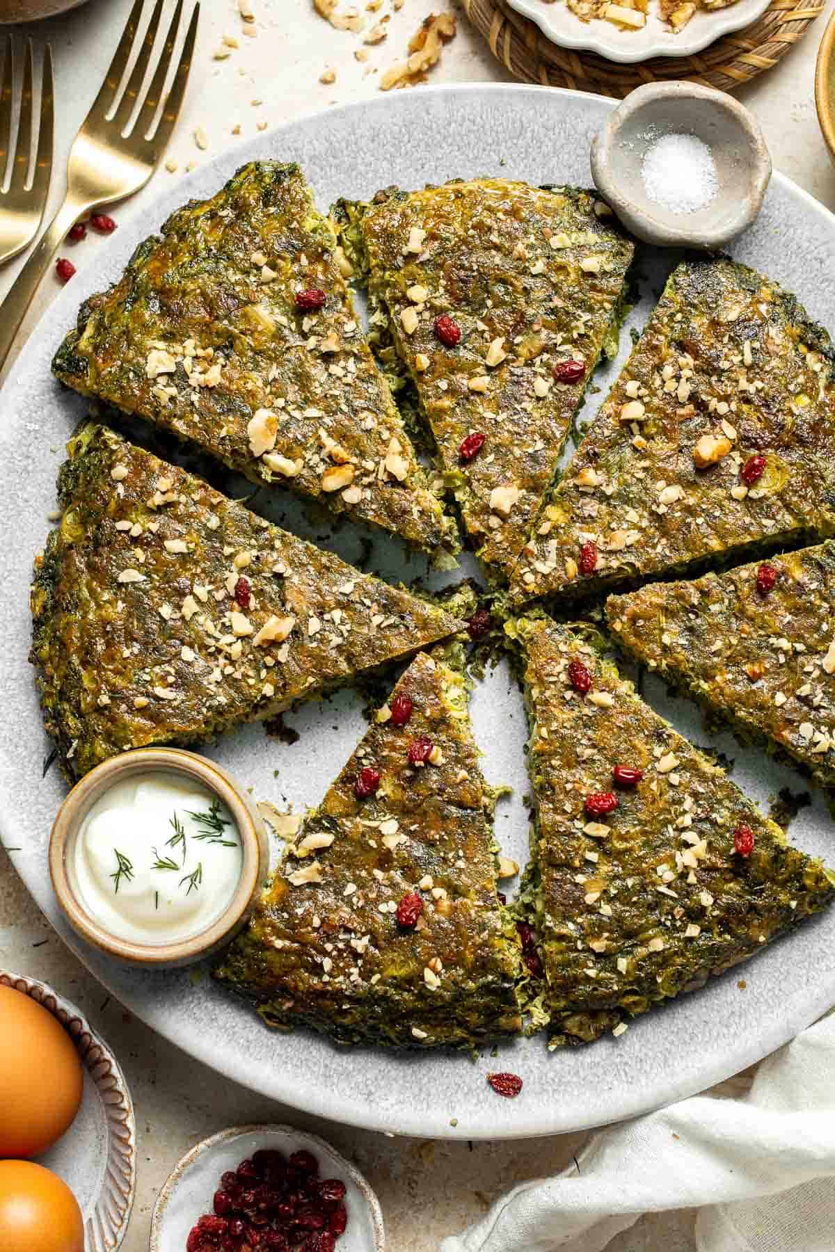 Kookoo Sabzi is a delicious and nutritious Persian frittata packed with fresh herbs, warm spices, and eggs. Serve as a delicious appetizer or side dish. | aheadofthyme.com
