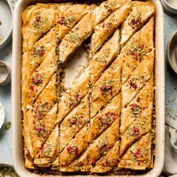 Persian Baklava is a crispy, flaky pastry layered with ground nuts, infused warm spices, and drenched in a fragrant rosewater and saffron honey syrup. | aheadofthyme.com