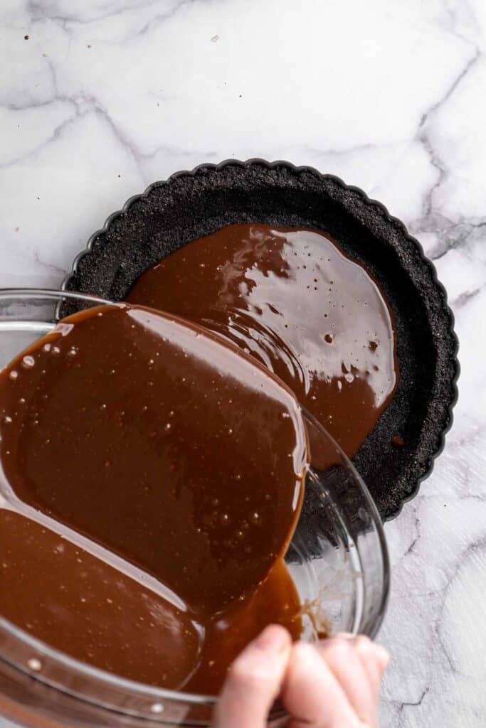 This Chocolate Tart is rich, decadent, and layered with the perfect balance of chocolate ganache and Oreo cookie crust. Way easier to make than you think! | aheadofthyme.com