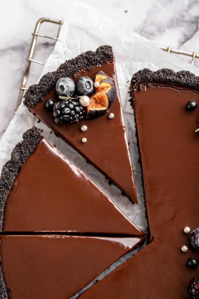 This Chocolate Tart is rich, decadent, and layered with the perfect balance of chocolate ganache and Oreo cookie crust. Way easier to make than you think! | aheadofthyme.com