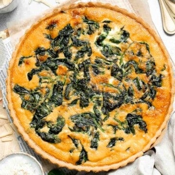 Spinach Quiche is a golden, savory classic with a tender flaky crust and a rich, creamy egg filling that’s packed with flavor. Surprisingly easy to make! | aheadofthyme.com