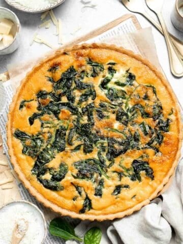 Spinach Quiche is a golden, savory classic with a tender flaky crust and a rich, creamy egg filling that’s packed with flavor. Surprisingly easy to make! | aheadofthyme.com