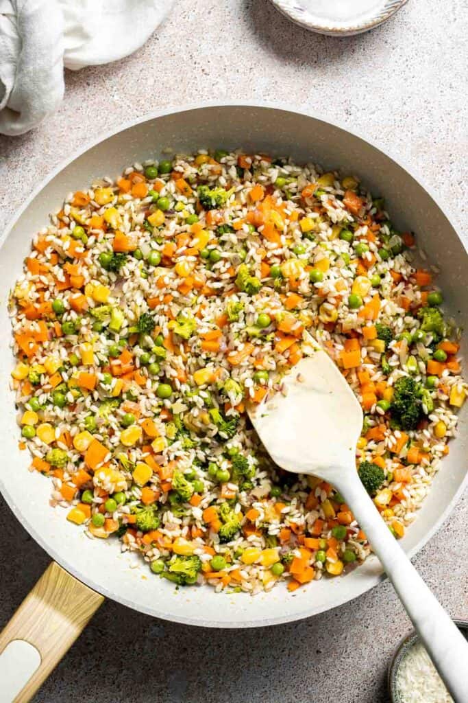This Vegetable Risotto is rich and creamy, loaded with tender vegetables and arborio rice. It's fancy but totally approachable for weeknight dinner! | aheadofthyme.com