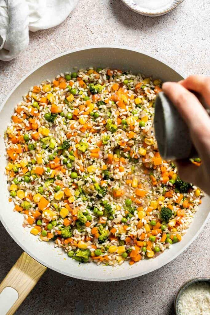 This Vegetable Risotto is rich and creamy, loaded with tender vegetables and arborio rice. It's fancy but totally approachable for weeknight dinner! | aheadofthyme.com